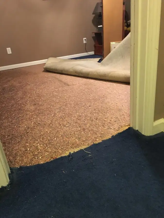 Carpet pad removal revealing water damage during Drying & Dehumidification in Smithville